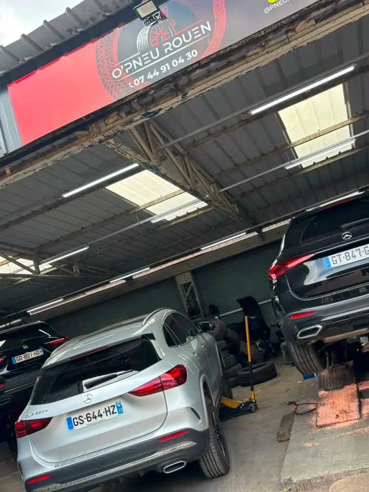 Intérieur du garage O'Pneus Rouen à Sotteville-lès-Rouen, véhicules sur cric